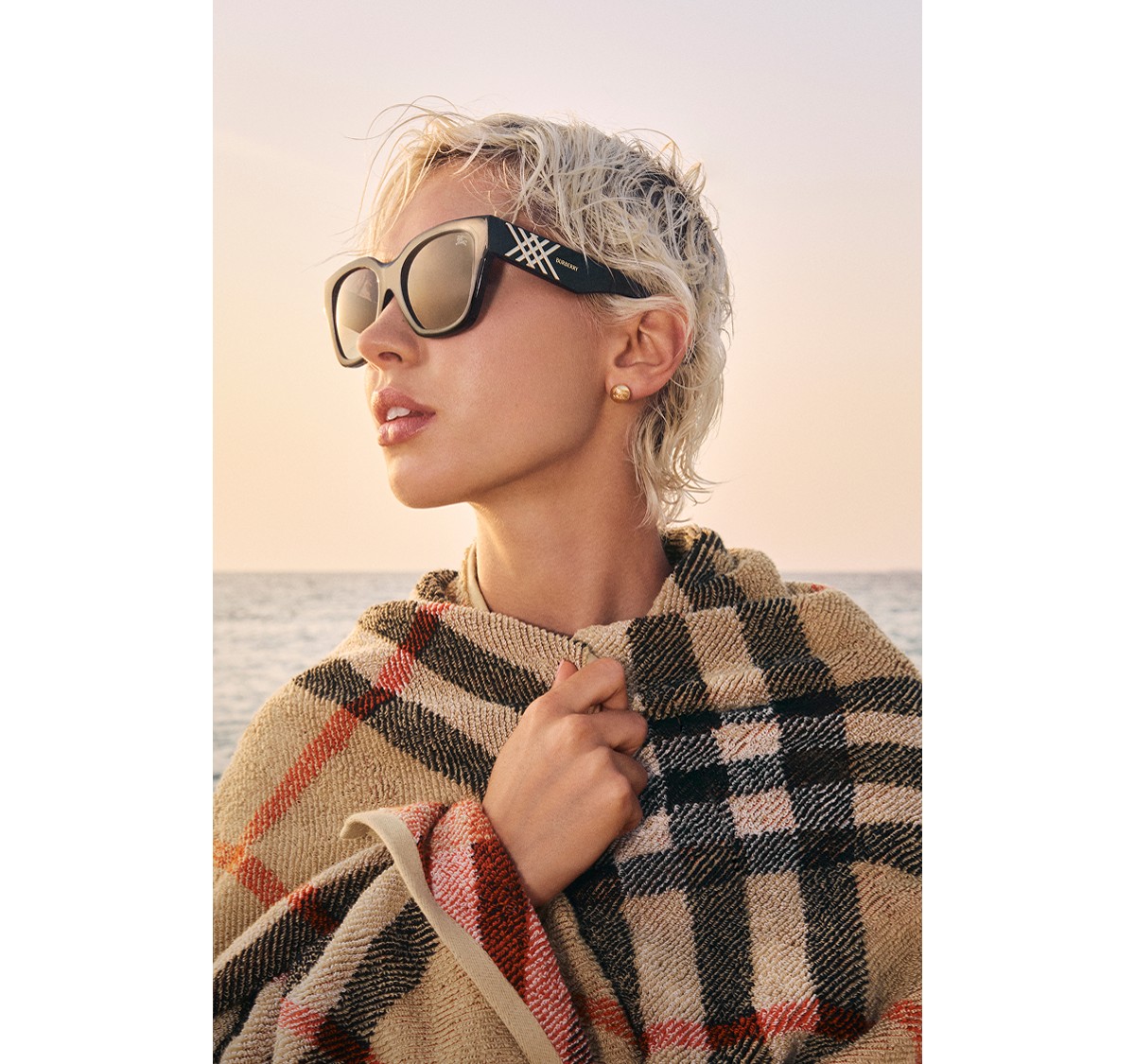 Official Burberry eyewear portrait of Iris Law wearing sunglasses and Burberry check