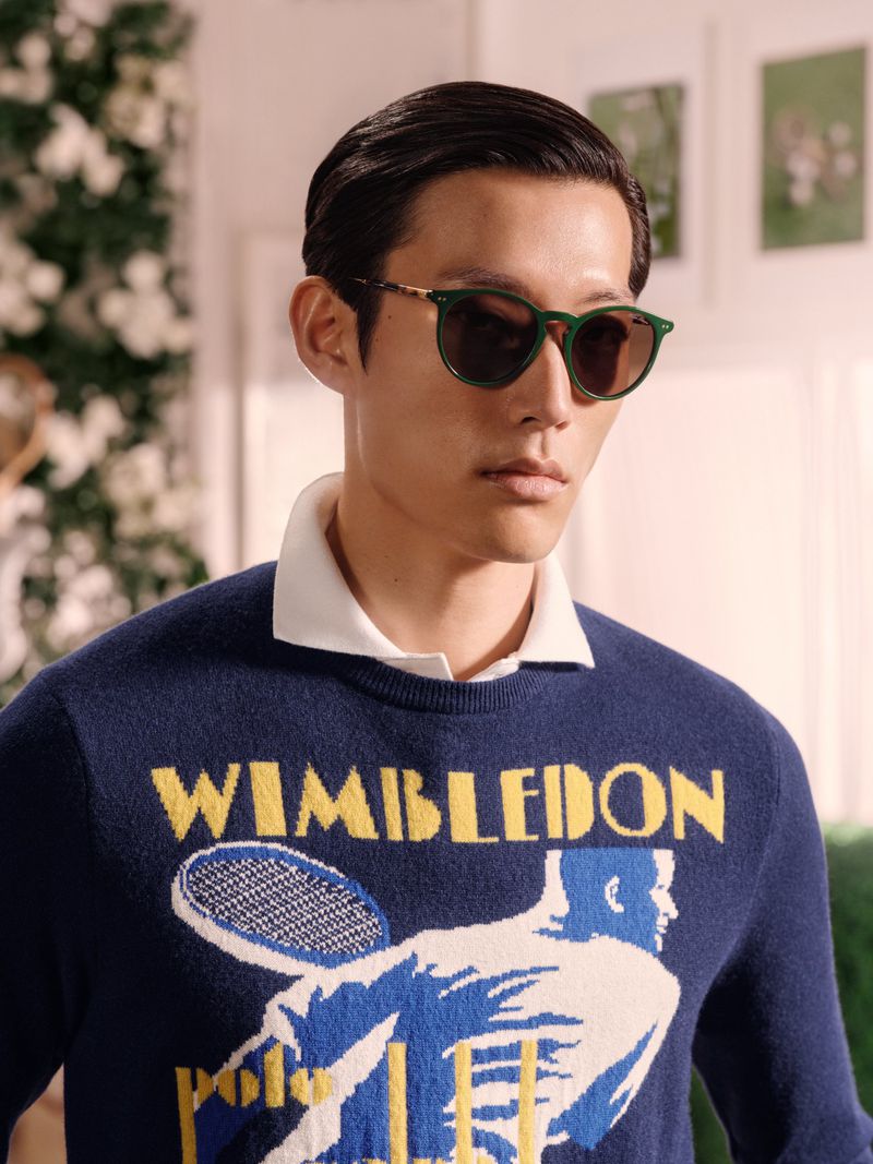 Polo Ralph Lauren campaign with green sunglasses and navy knitwear