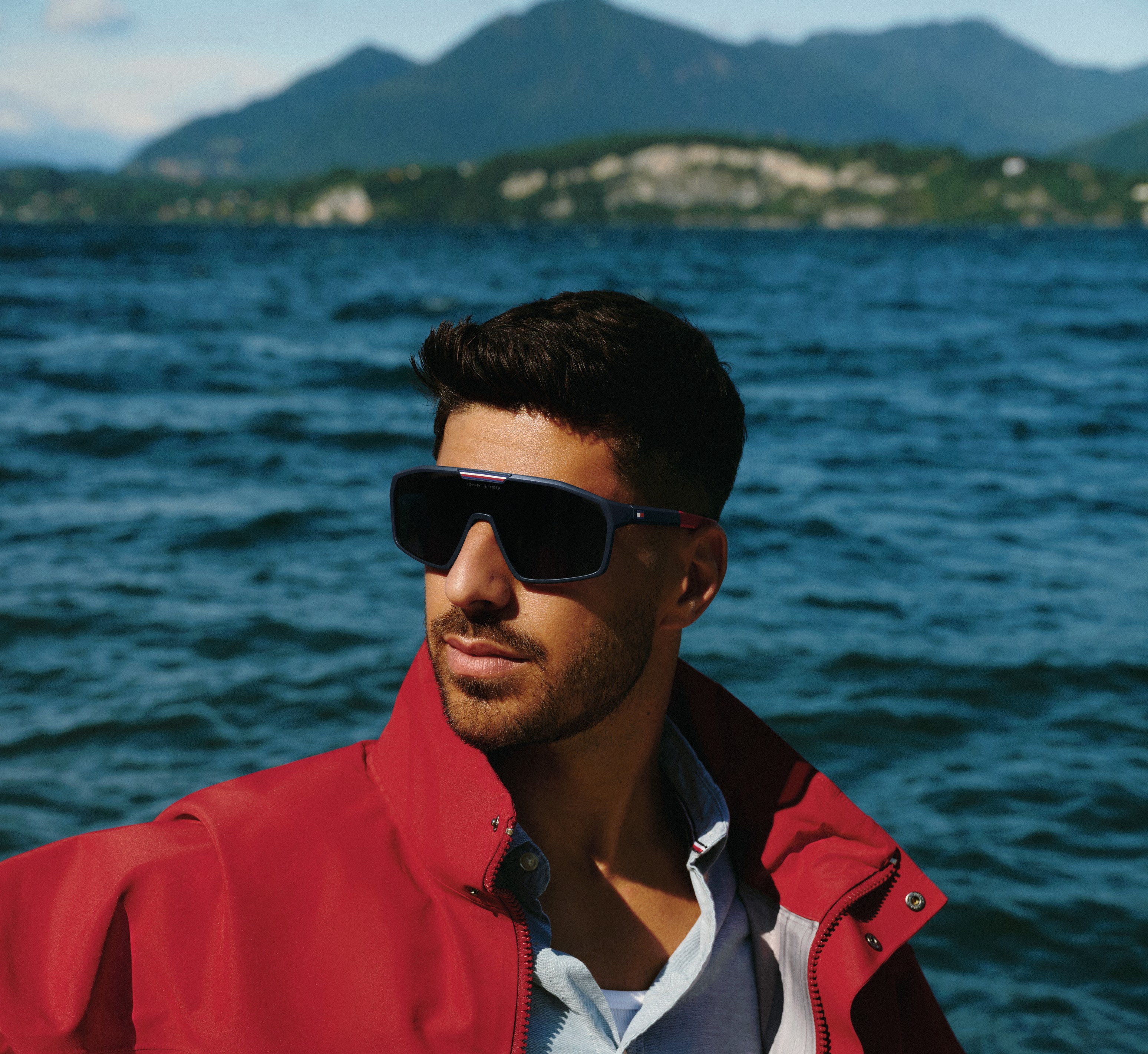 Tommy Hilfiger eyewear campaign, red jacket and sunglasses by the water