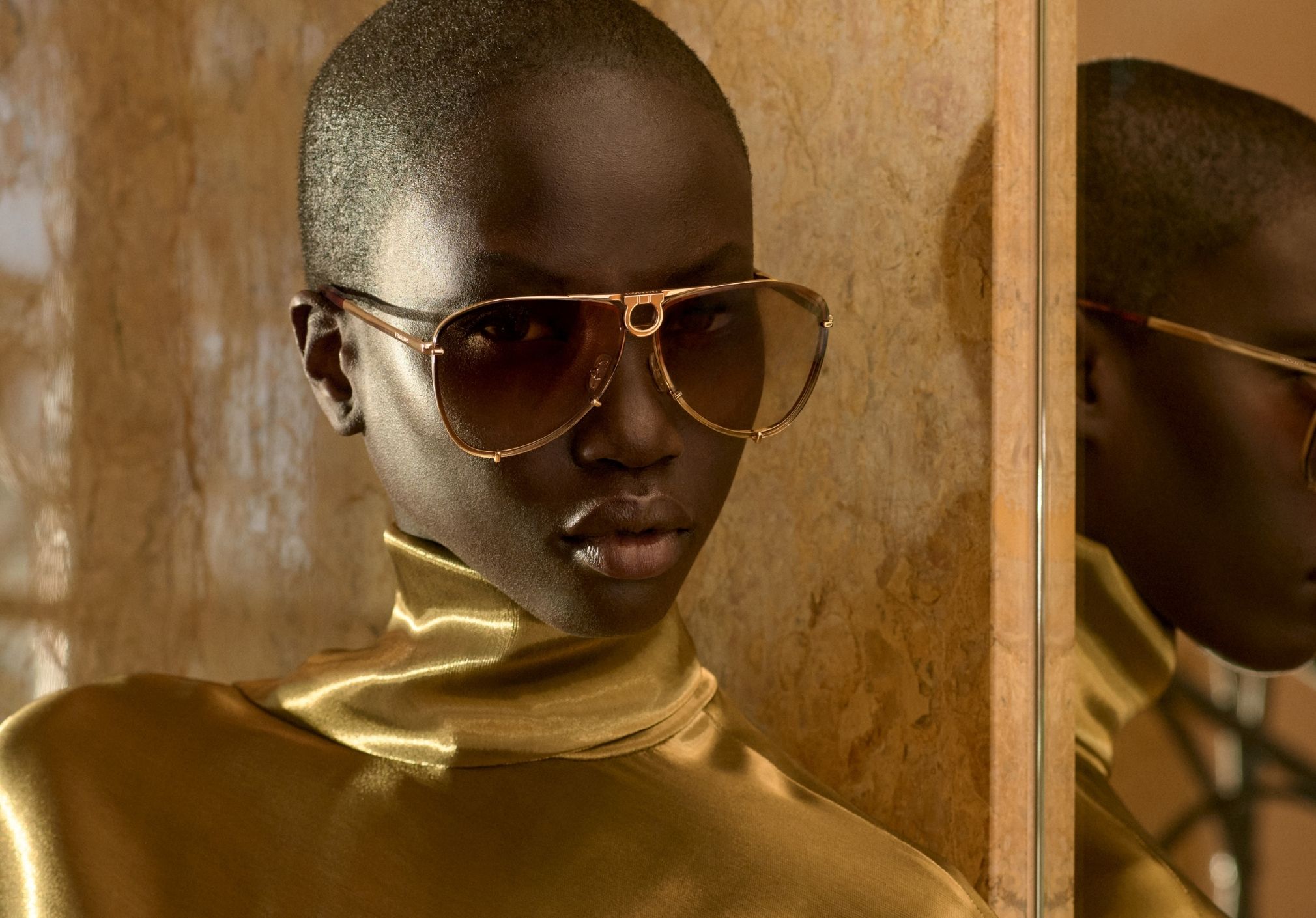 Official Ferragamo eyewear campaign: gold frames and mirrored portrait